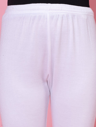 White solid woolen leggings with elasticated waistband and drawstring closure.