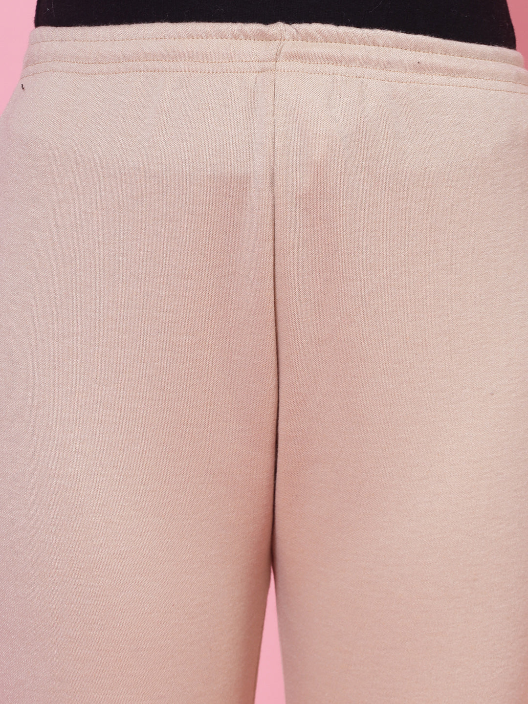 White and light fawn solid woolen leggings with elasticated waistband and drawstring closure.