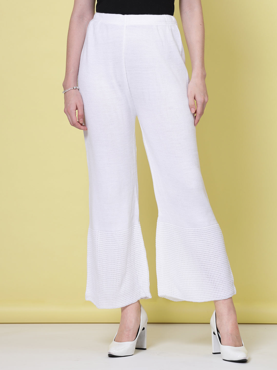 White and red solid woolen palazzo pants with elasticated waistband.