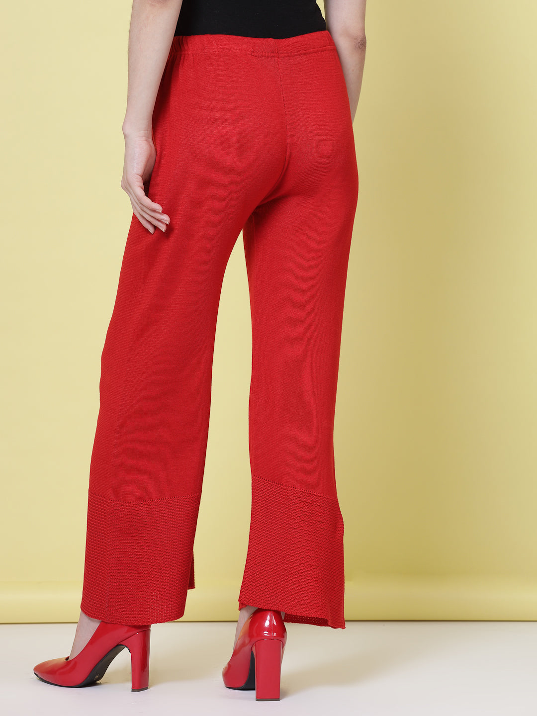 White and red solid woolen palazzo pants with elastic waistband.