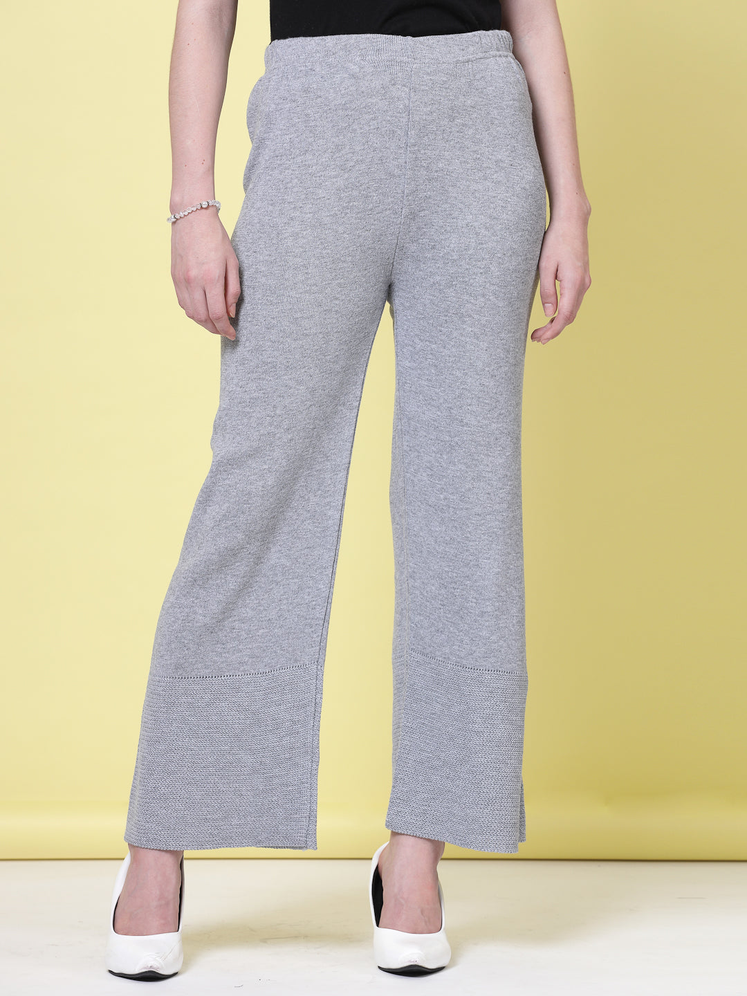 White and light grey solid woolen palazzo pants with elastic waistband.