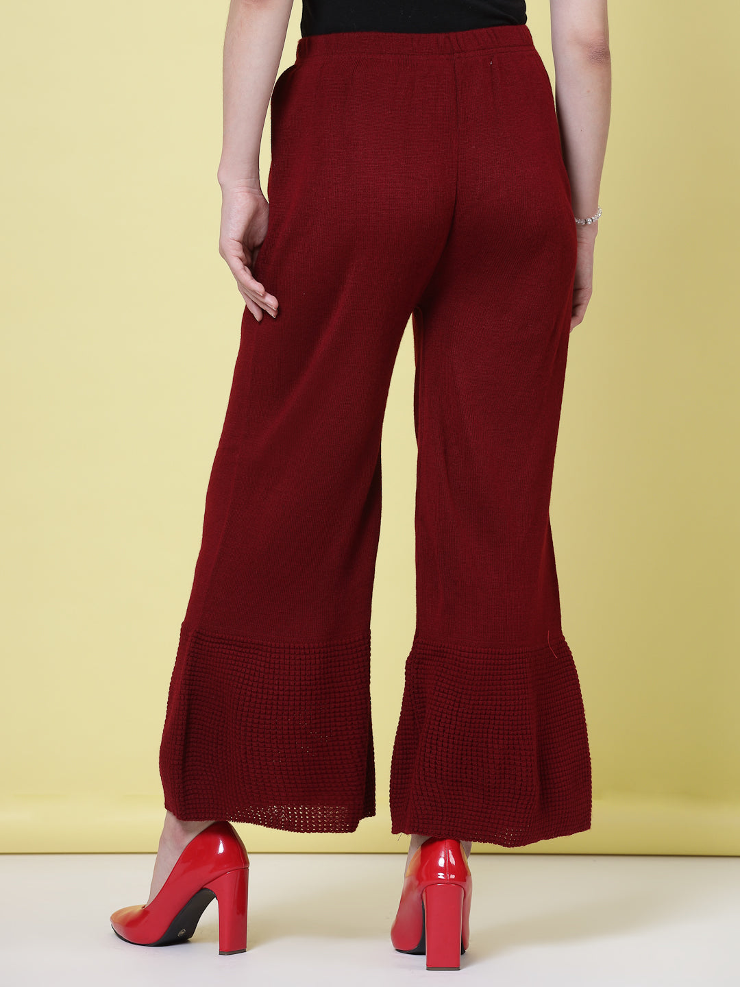 Red and maroon solid woolen palazzo pants with elasticated waistband.