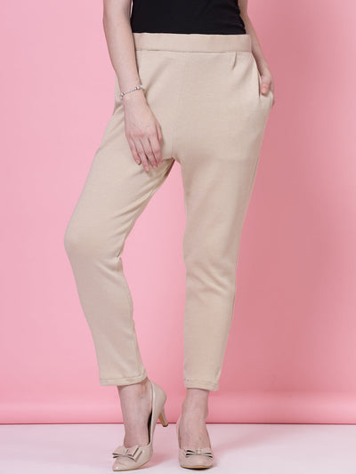 White and light fawn solid woolen trousers with elastic waistband and side pockets.