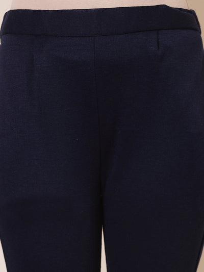 White and navy blue solid woolen trousers with elasticated waistband and side pockets.