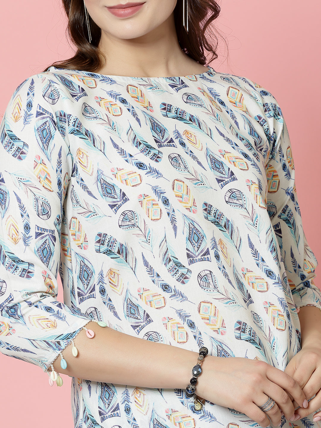 Printed tunic with three-quarter sleeves and boat neck featuring a colorful pattern.