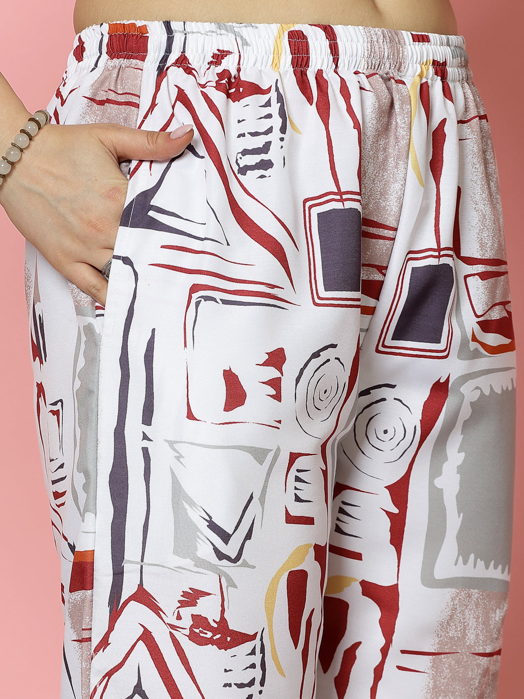 White abstract printed kurti and trousers set with geometric patterns, V-neck, and elasticated waistband.