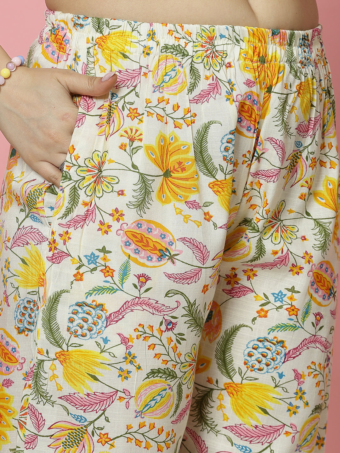 Yellow and off-white floral printed trousers with elasticated waistband.