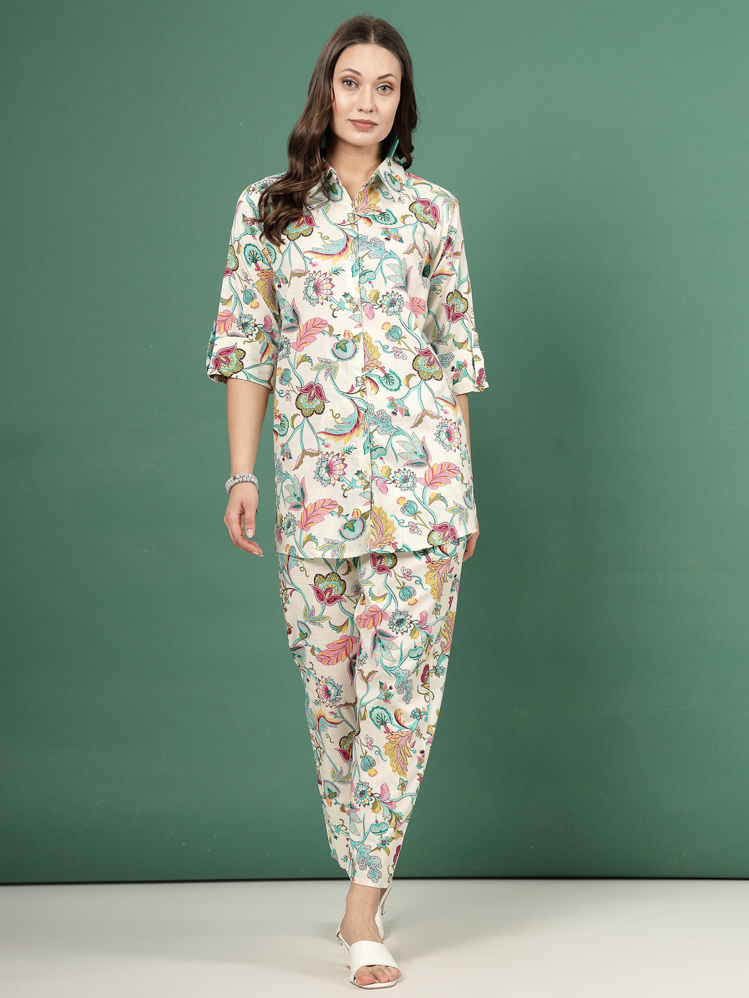 Multi printed shirt with floral design and roll-up sleeves paired with matching trousers, green and off-white.