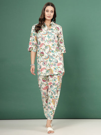 Multi printed shirt with floral design and roll-up sleeves paired with matching trousers, green and off-white.