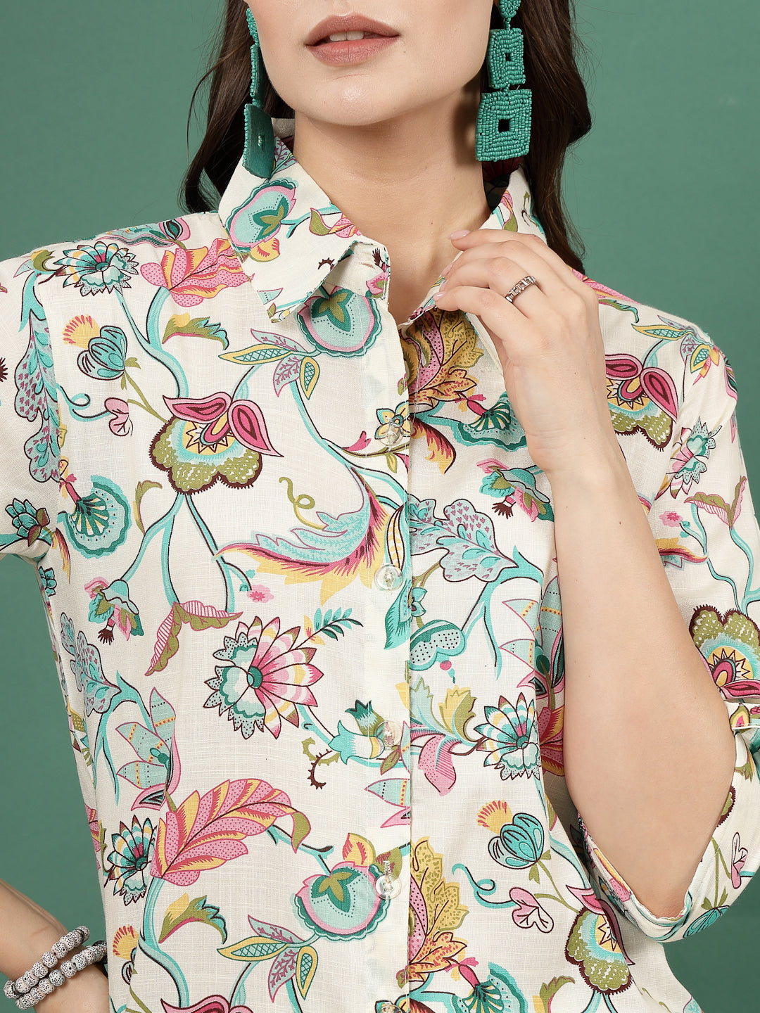 Multi printed shirt with floral design, roll-up sleeves, and button closure.