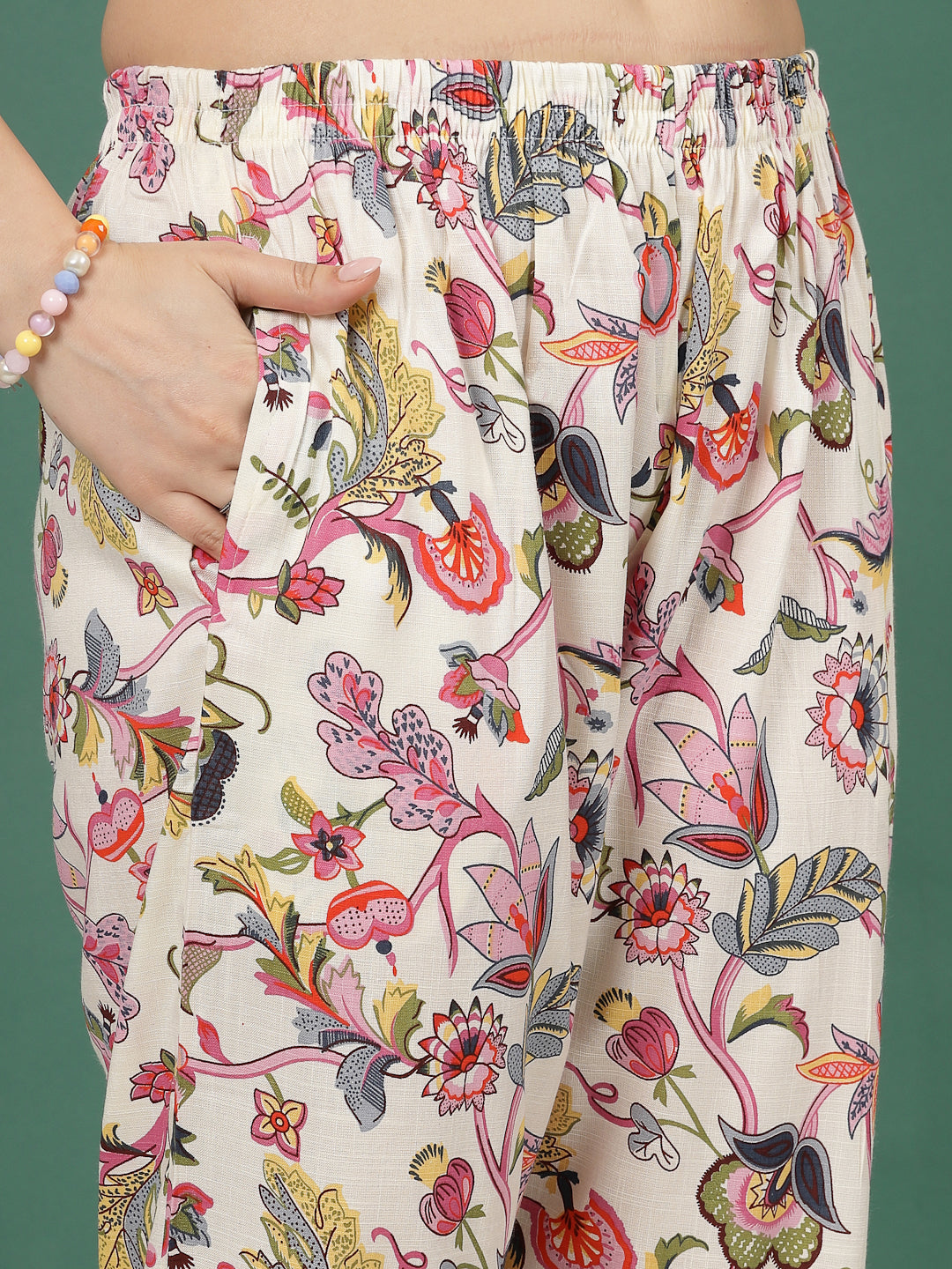 Multi printed floral trousers with pink and off-white design, elastic waistband.