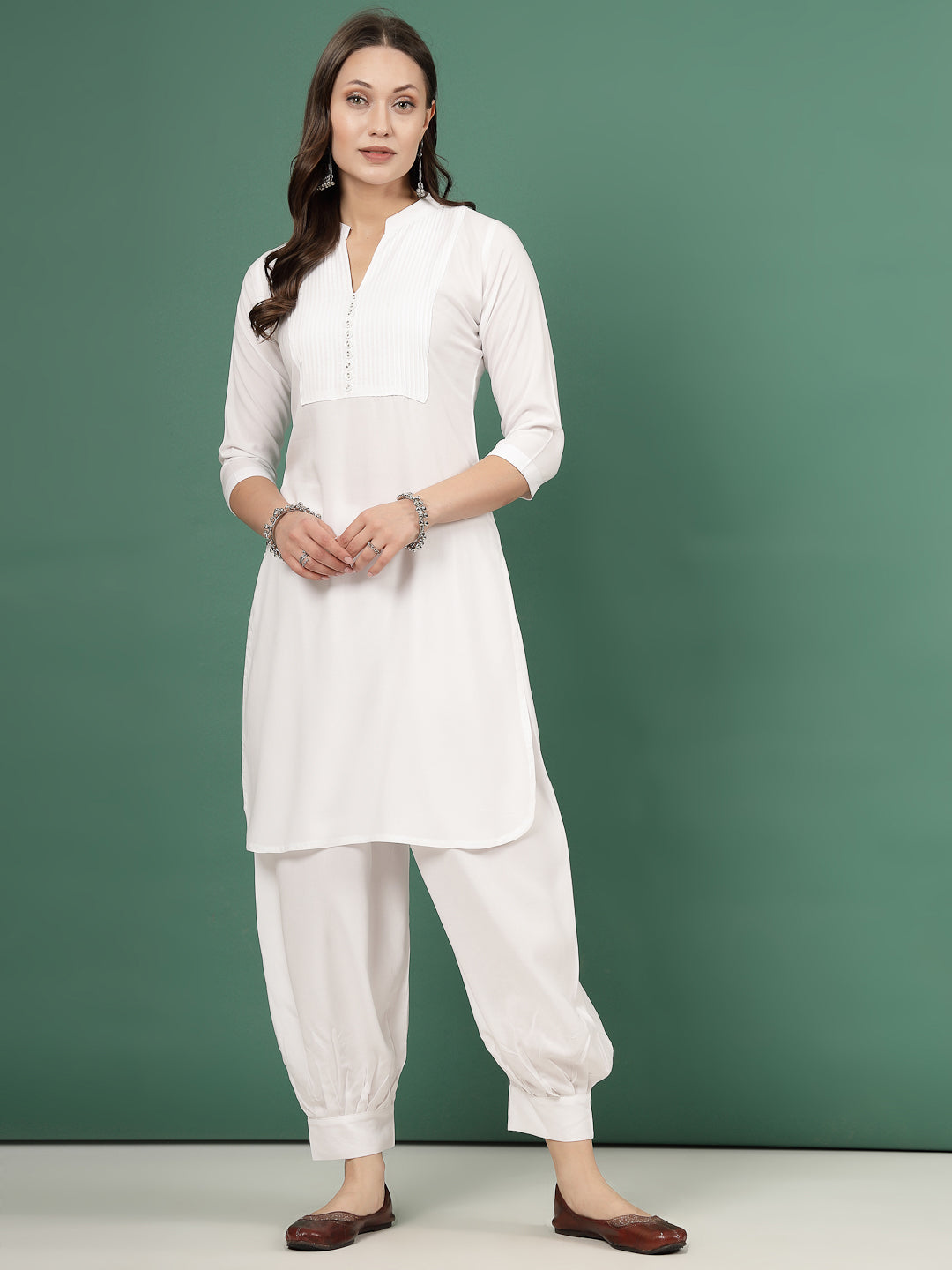 Yoke design kurta with Afghani pants, white color, three-quarter sleeves, mandarin collar, curved hem.