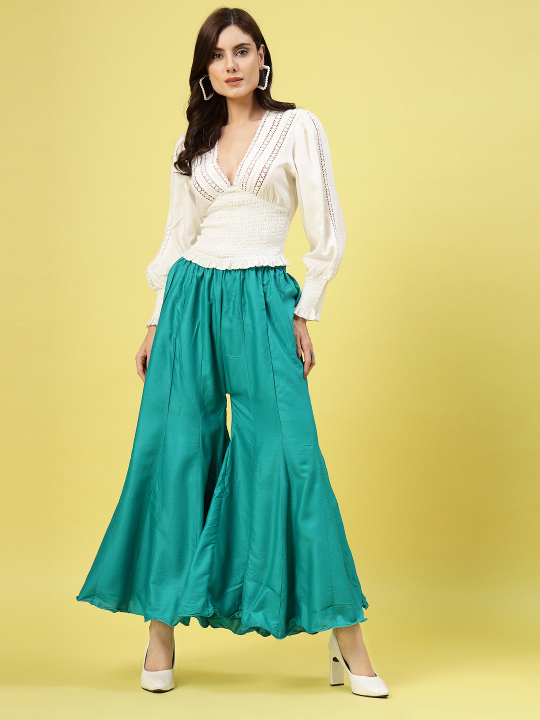 Women Solid Rama Green Flared Rayon Sharara with elasticated waistband and drawstring closure.