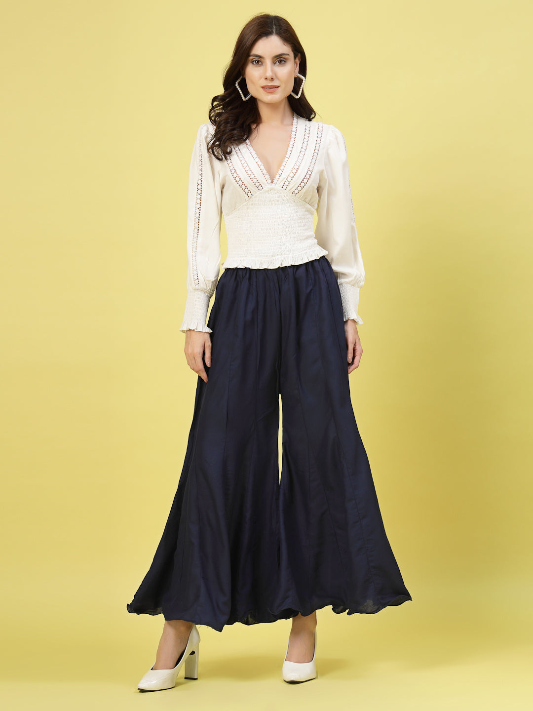 Women wearing navy blue flared rayon sharara with an elasticated waistband and drawstring closure.