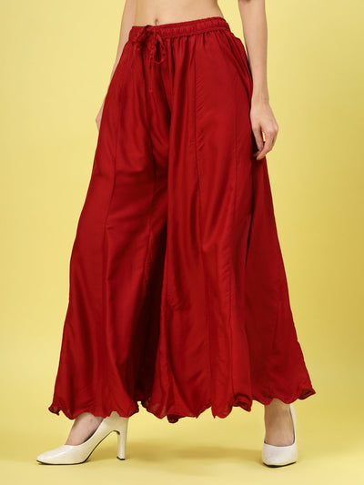 Women solid maroon flared rayon Sharara with elasticated waistband and drawstring closure.