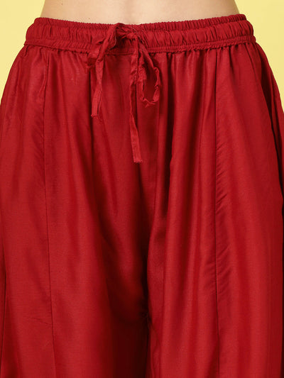 Women solid maroon flared rayon sharara with elasticated waistband and drawstring closure.