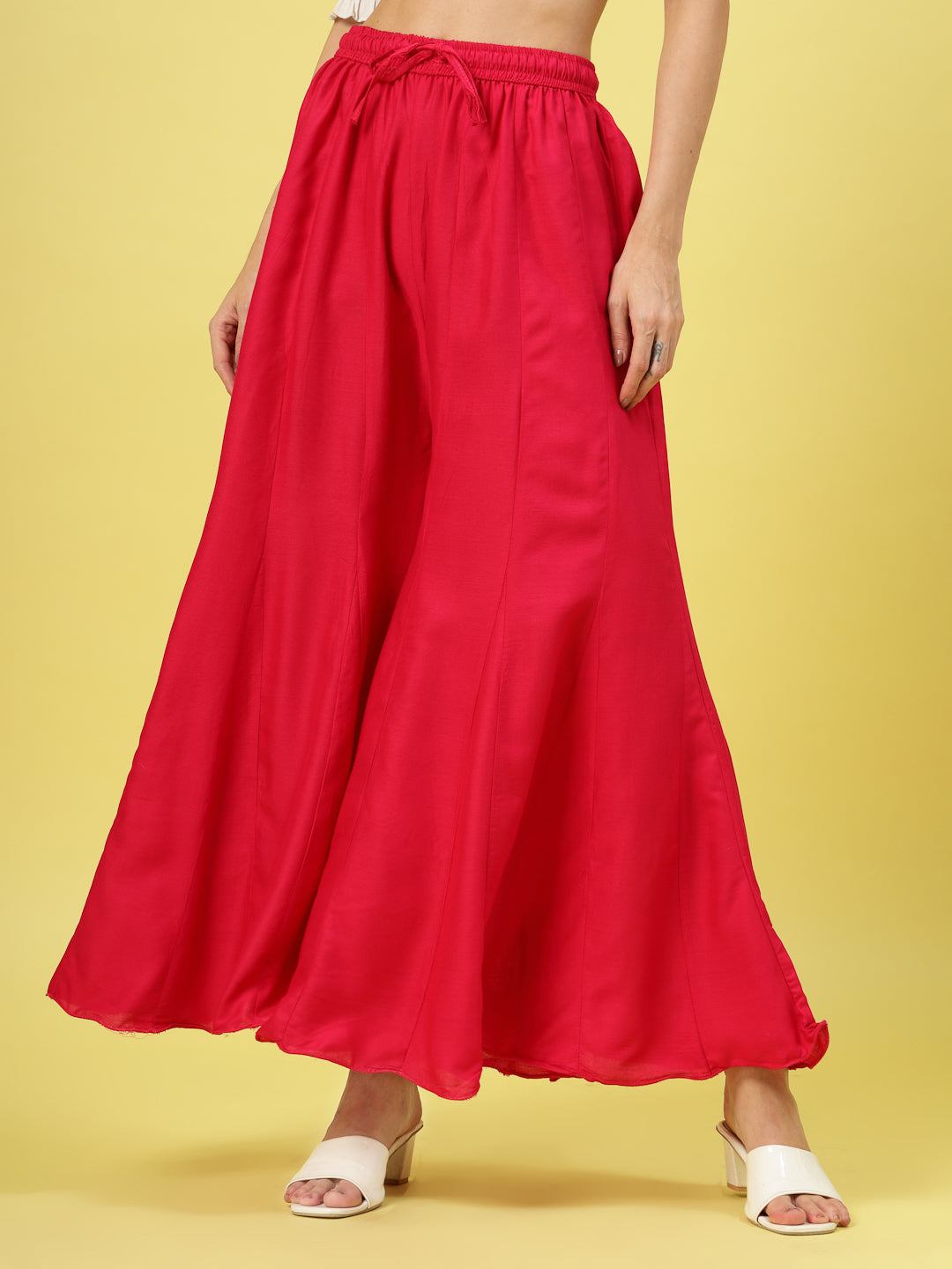 Women solid red flared rayon sharara with elastic waistband and drawstring closure.