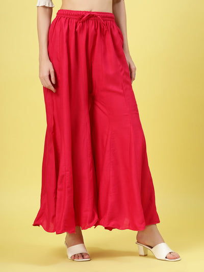 Women solid red flared rayon sharara with elasticated waistband and drawstring closure.