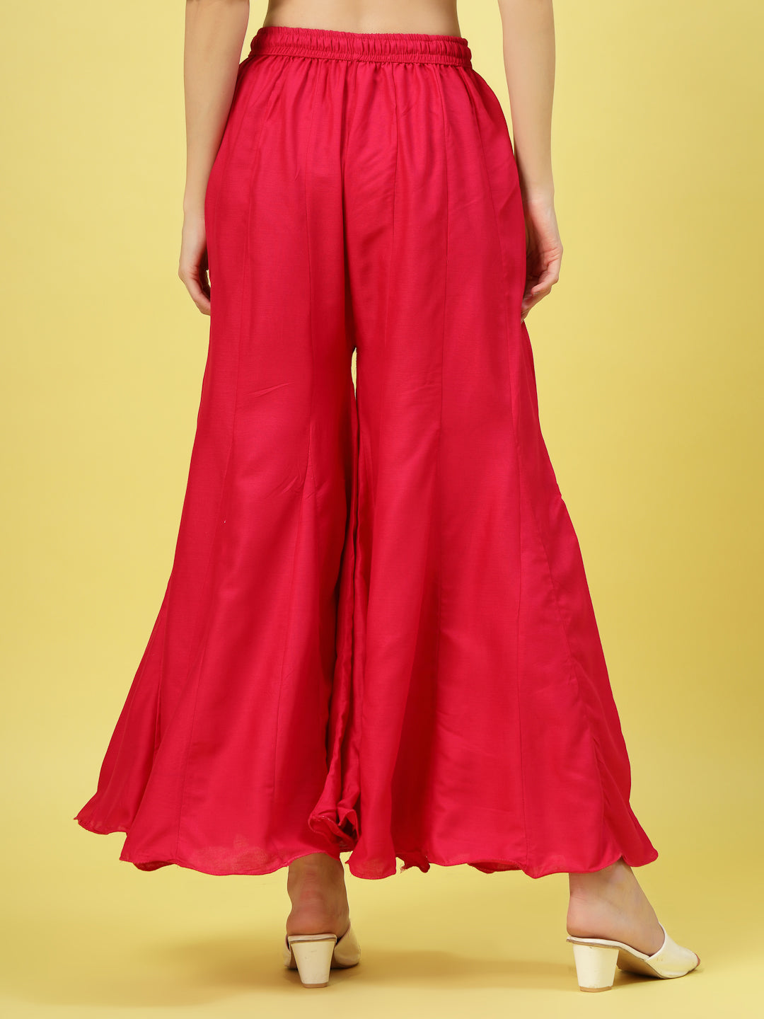 Women solid red flared rayon sharara with elasticated waistband.