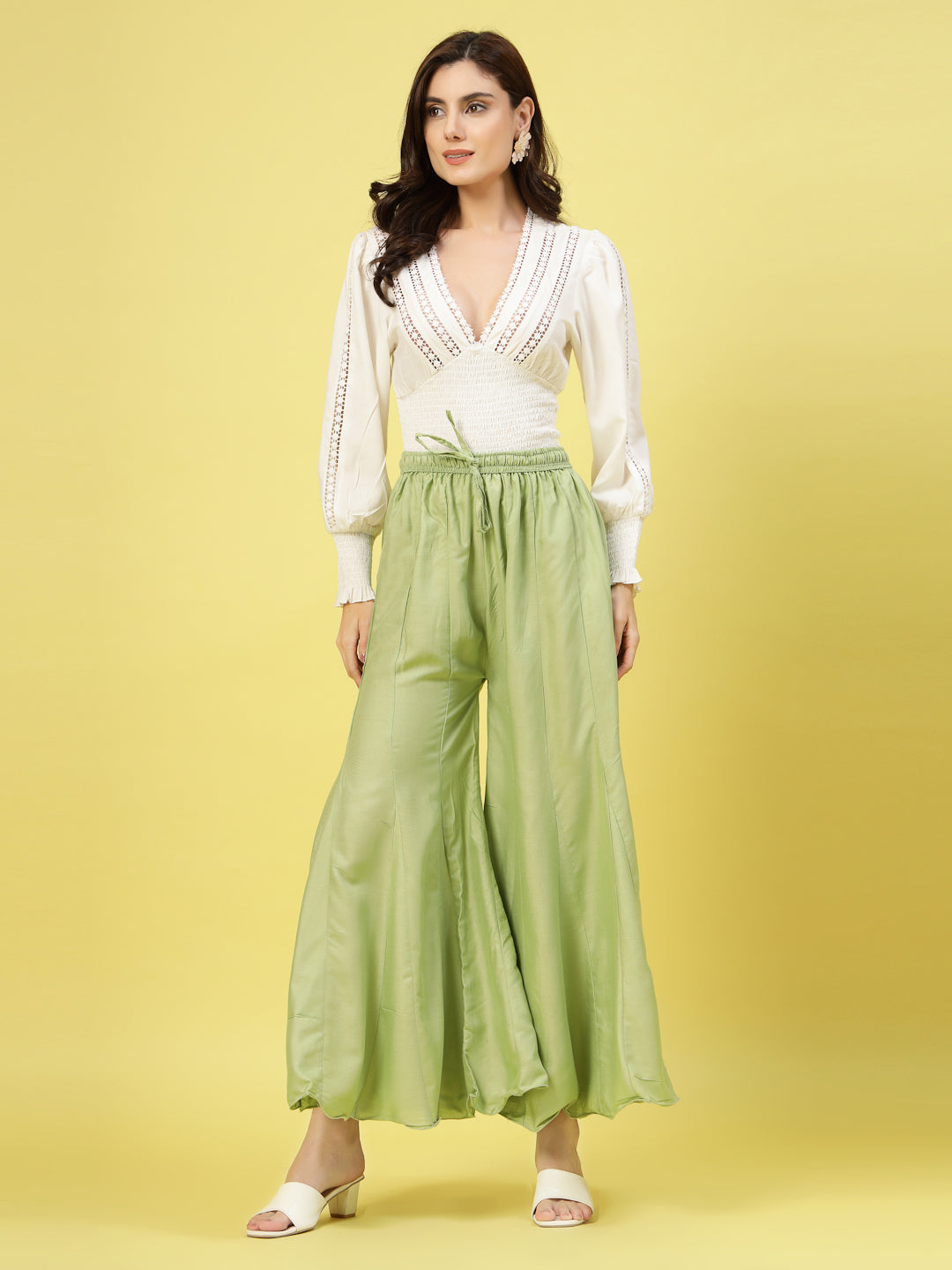 Women solid pista green flared rayon sharara with elastic waistband.