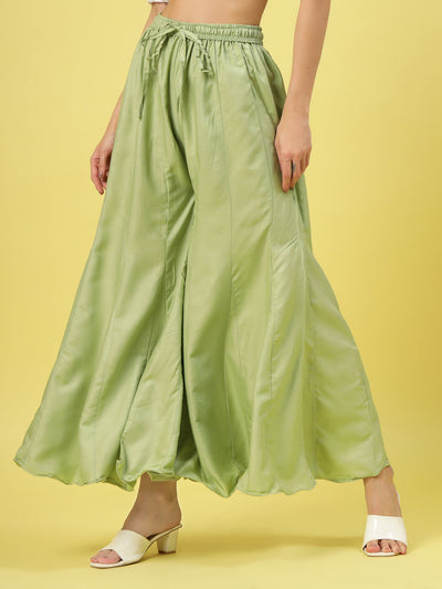 Women solid pista green flared rayon sharara with elasticated waistband.