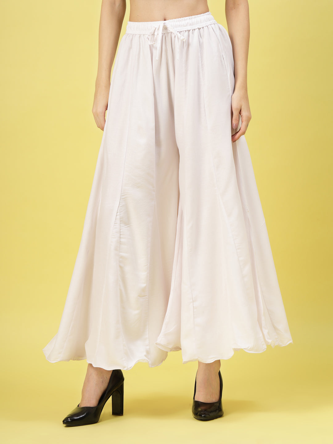 Women solid white flared rayon sharara with elastic waistband and drawstring closure.