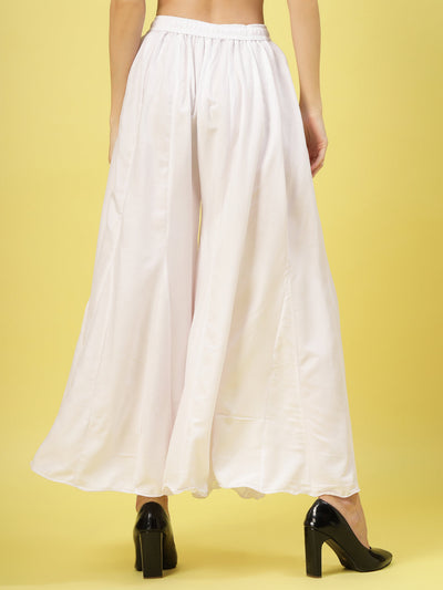 Women solid white flared rayon sharara with elasticated waistband and drawstring closure.