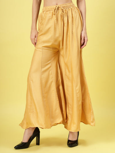 Women solid fawn flared rayon Sharara with elasticated waistband and drawstring closure.