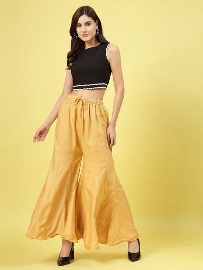 Women solid fawn flared rayon sharara with elasticated waistband.