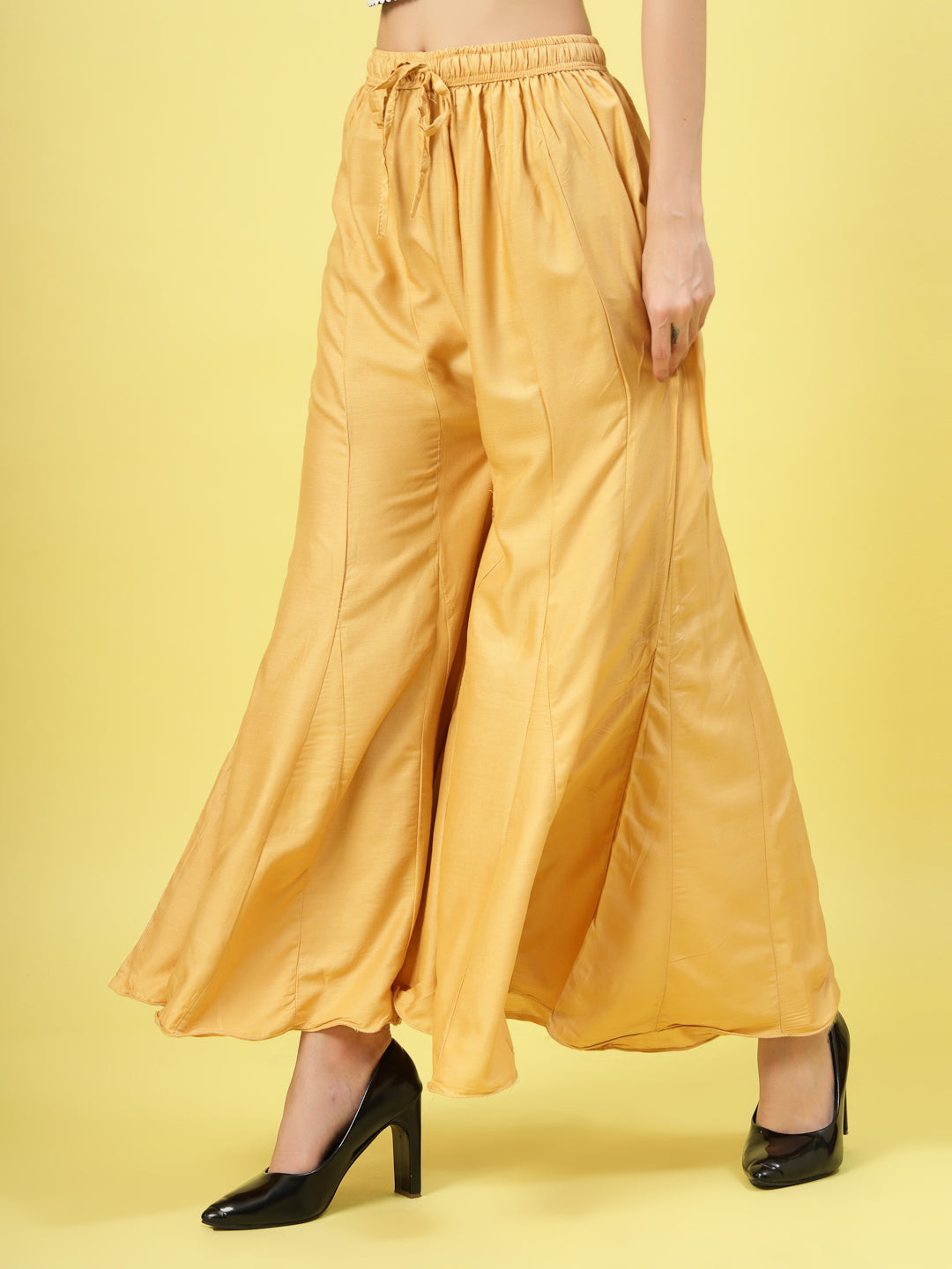 Women solid fawn flared rayon sharara with elasticated waistband and drawstring closure.