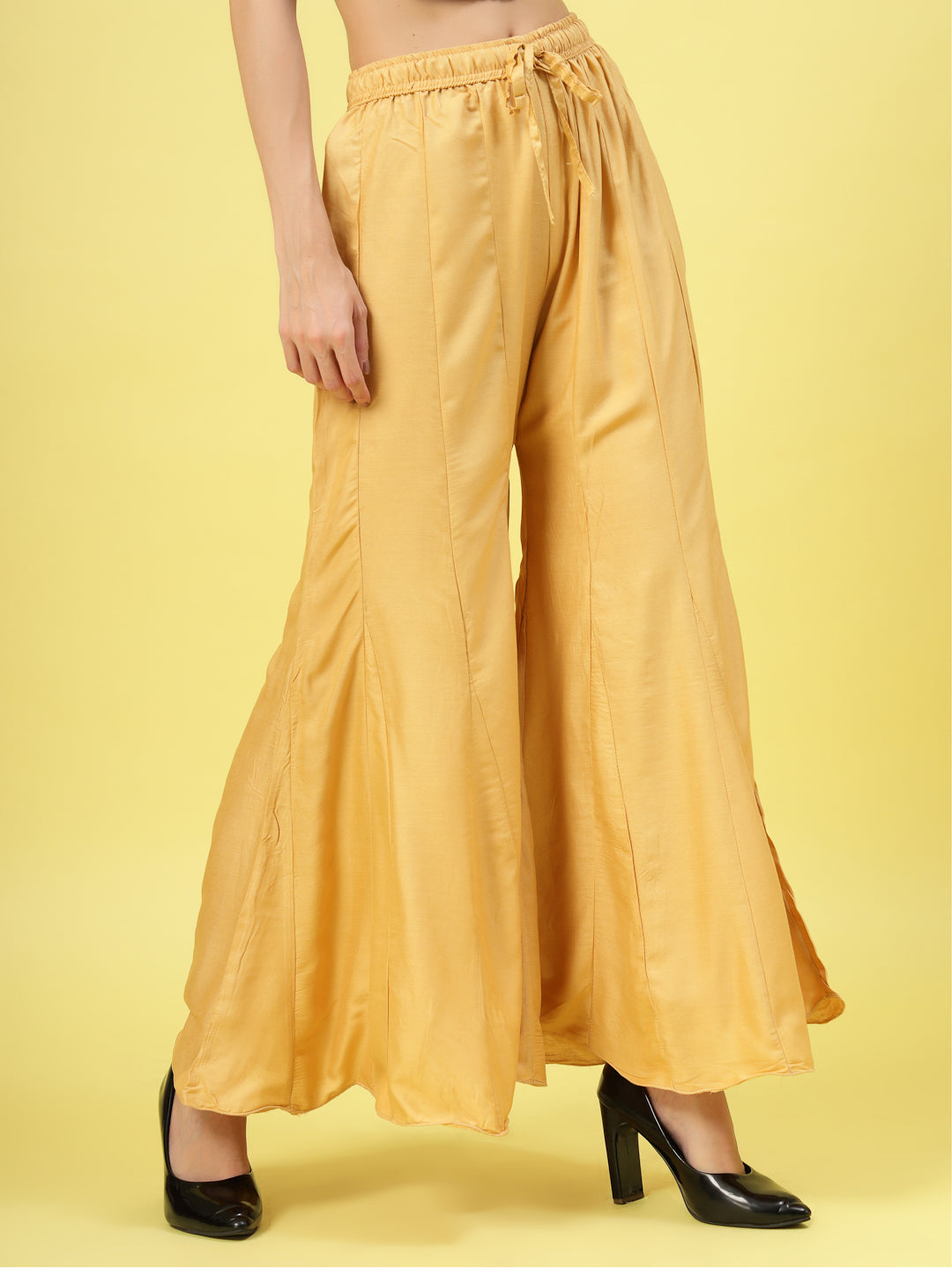 Women solid fawn flared rayon sharara with elasticated waistband and drawstring closure.