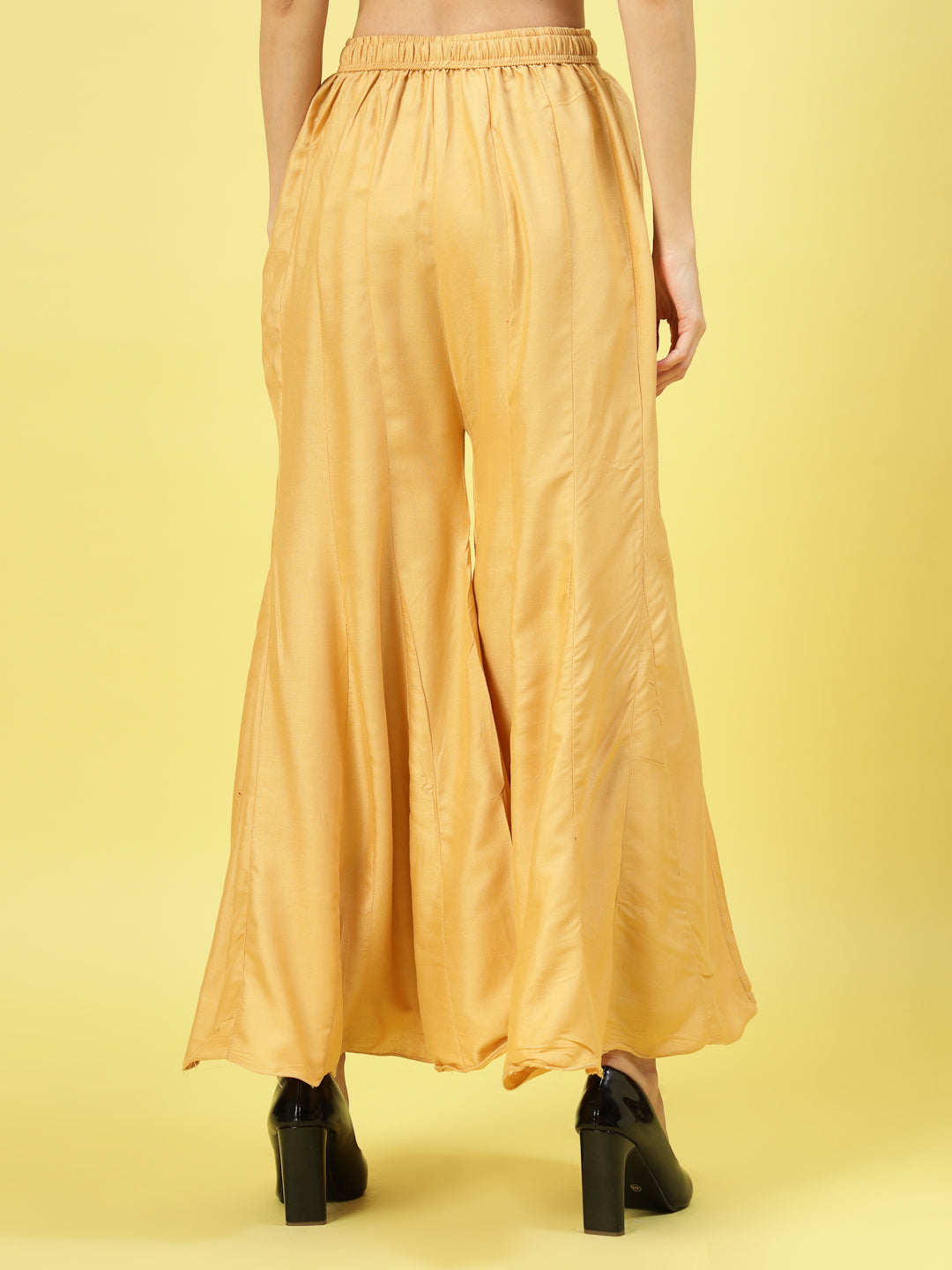 Women solid fawn flared rayon sharara with elasticated waistband.