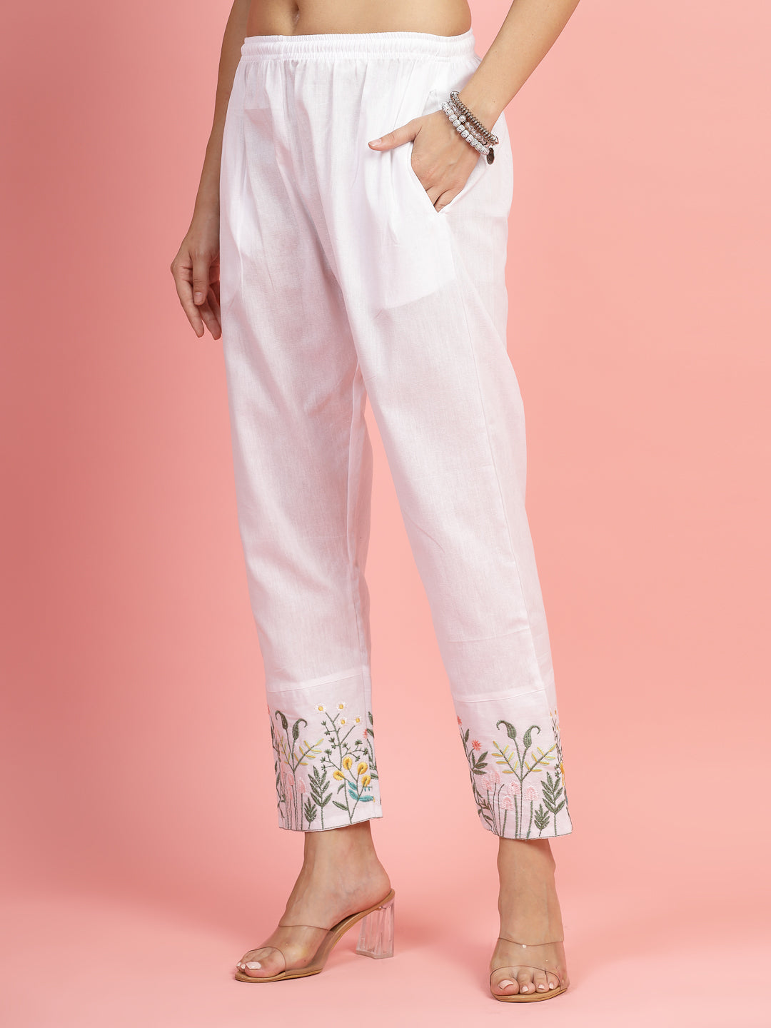 Women embroidered hem design mid rise pants with regular fit and flat-front style.