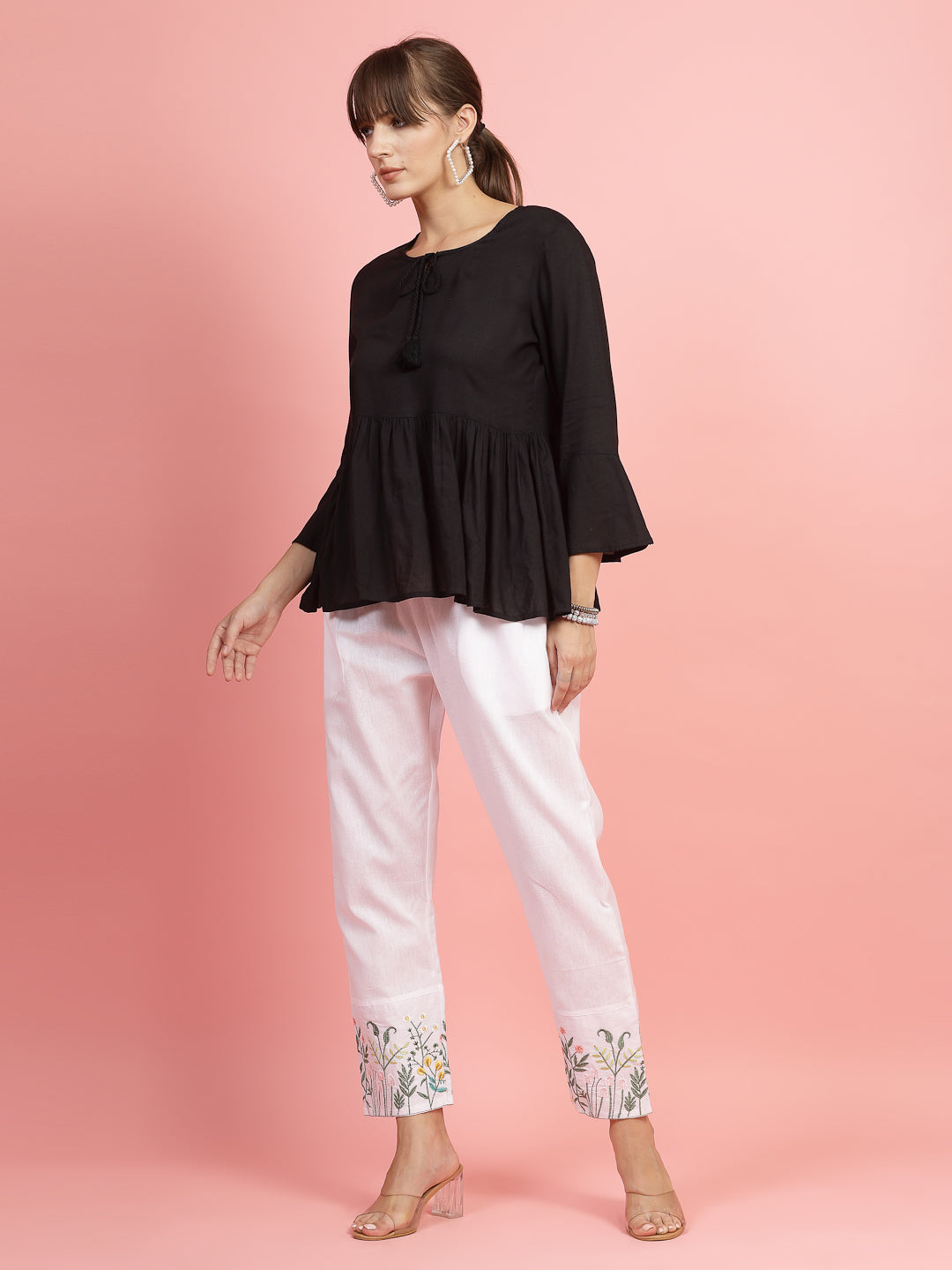 Women embroidered hem design mid-rise pants with regular fit and flat-front style.