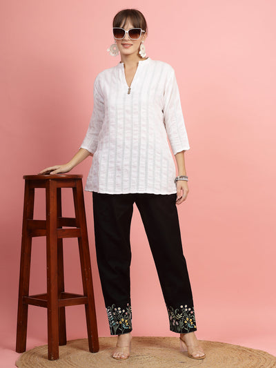 Women embroidered hem design mid-rise pants with regular fit and flat-front style.