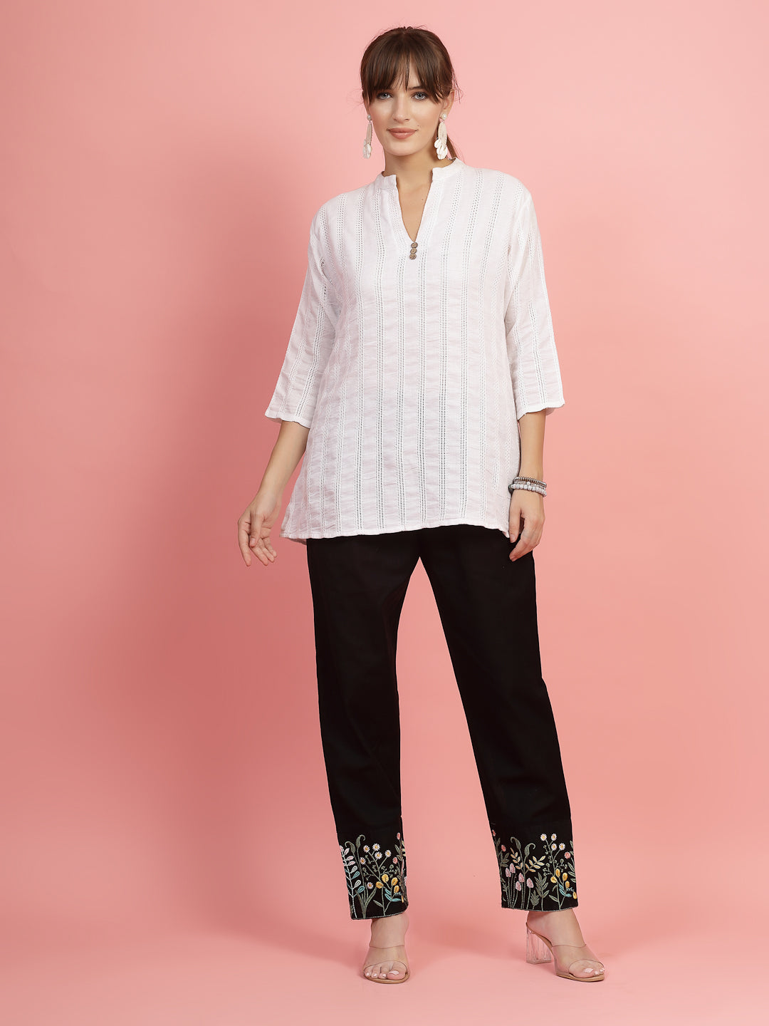 Women embroidered hem design mid-rise pants with regular fit and flat-front design.