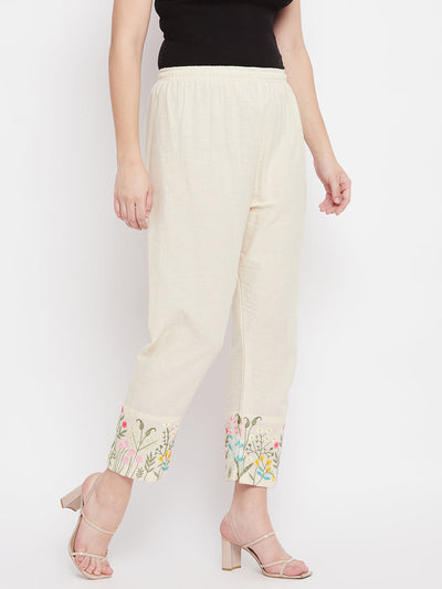 Women embroidered hem design mid rise pants with regular fit and flat-front pattern.