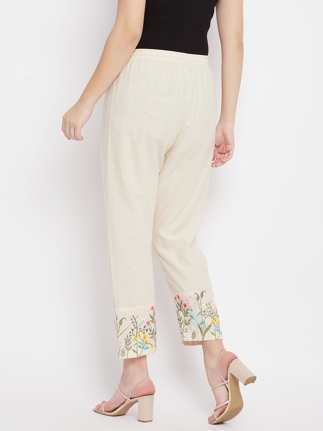 Women mid-rise pants with embroidered hem design and regular fit.