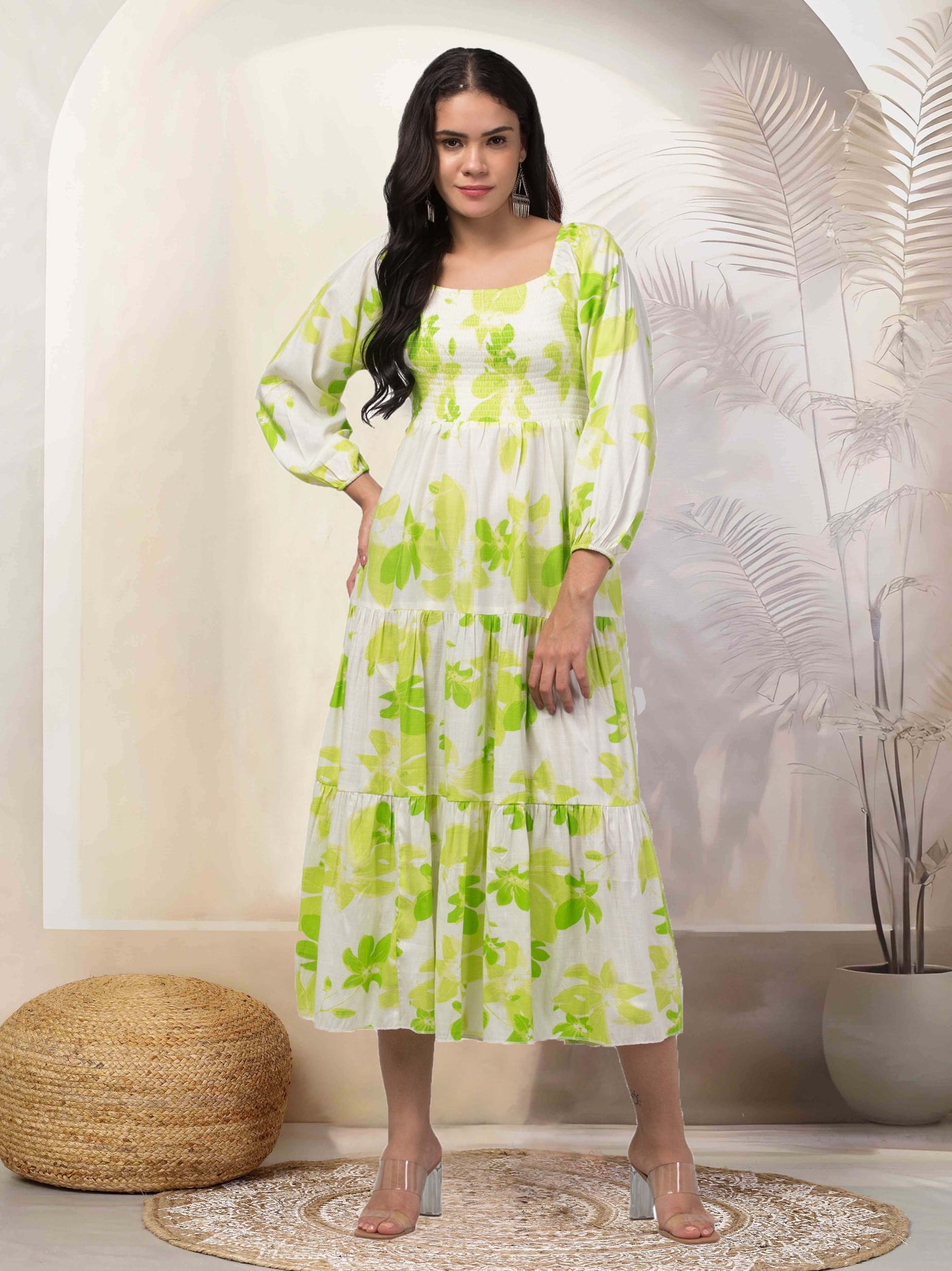 Women in parrot green fit & flare dress with floral print.