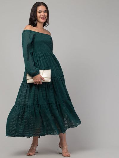 Women wearing a bottle green printed fit & flare Georgette dress, showcasing off-shoulder design.