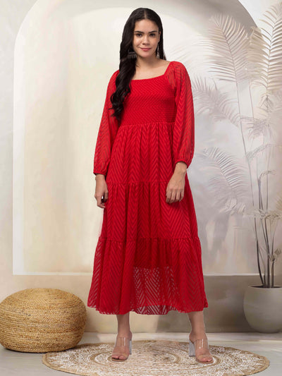 Women in a red printed fit & flare dress made from Georgette fabric.