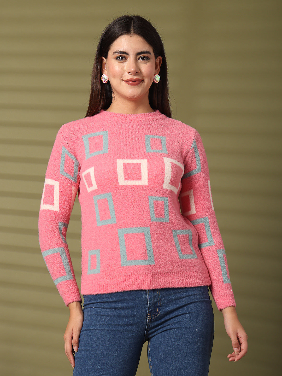 Pink woolen regular top with geometric patterns and full sleeves, worn with blue jeans.