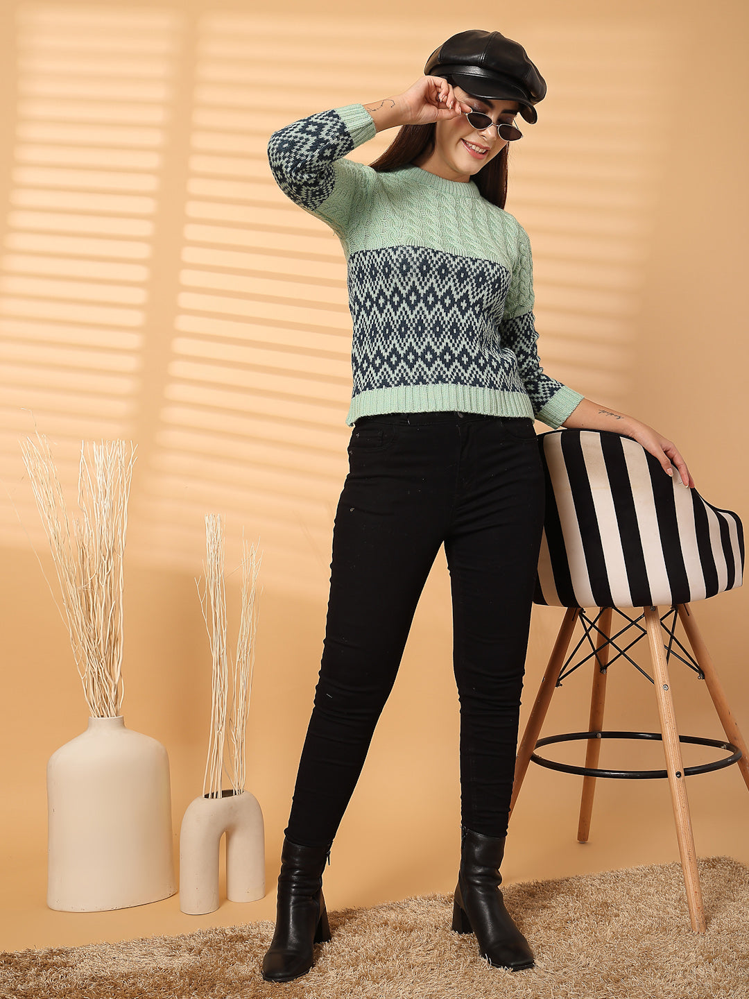 Pista green self-design woolen regular top with full sleeves, paired with black pants and a cap.