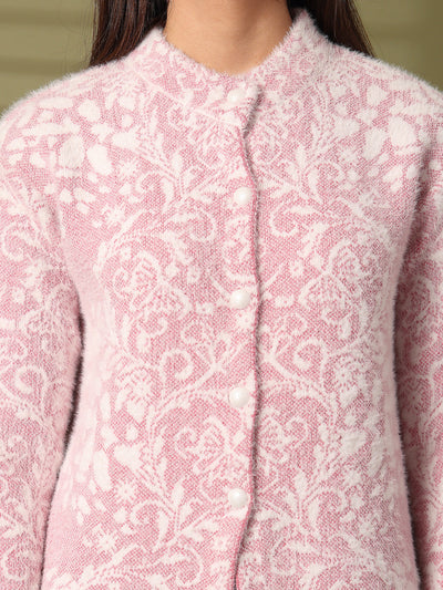 Pink woolen knitted cardigan with floral pattern and white buttons.