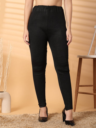 Women black solid woolen leggings with unique hem design.