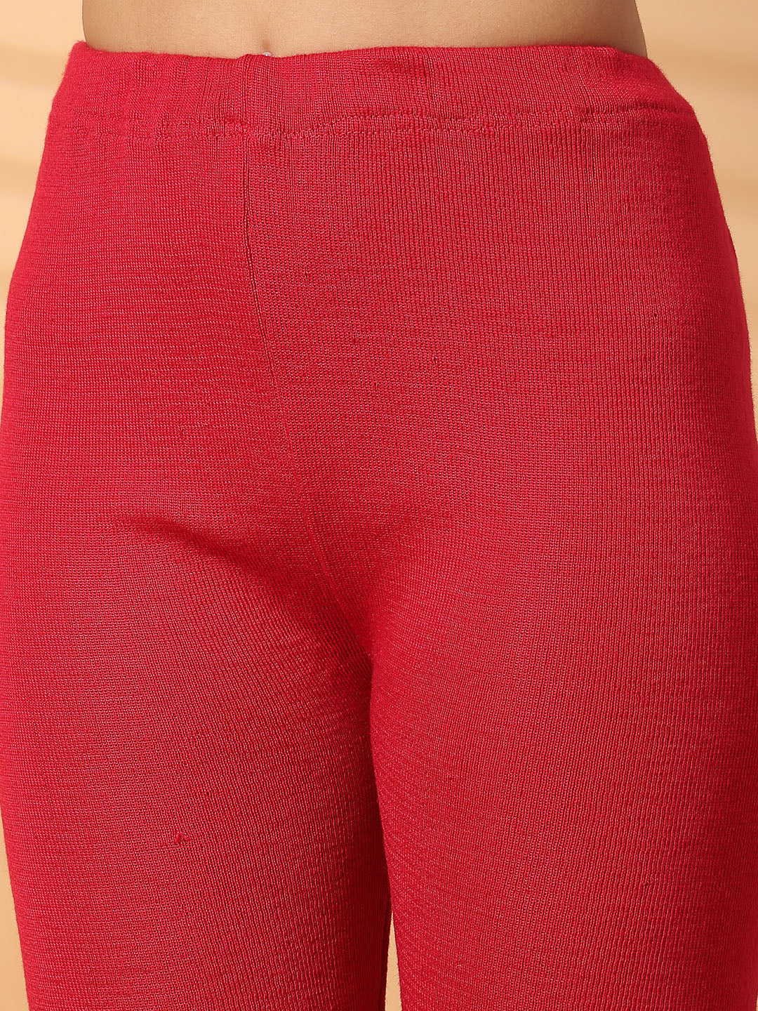 Women magenta solid woolen leggings with a unique hem design, offering a snug and comfortable fit.