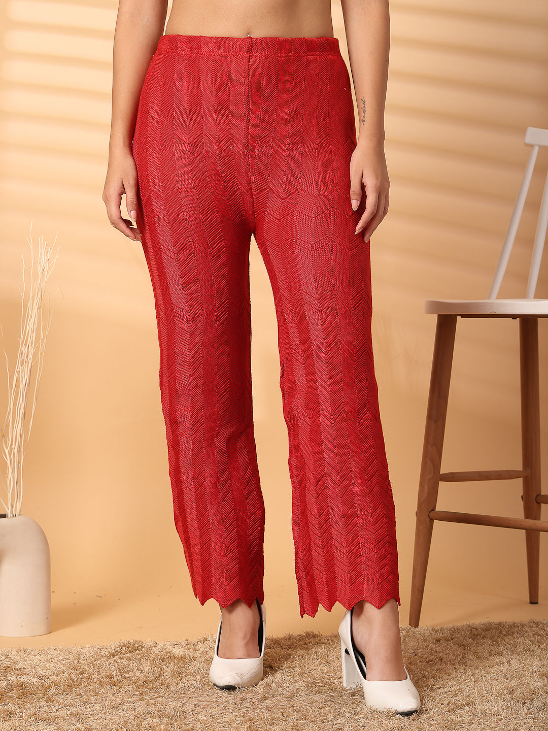 Red solid cut work woolen palazzo with intricate hem detailing.