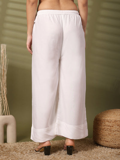 White solid rayon straight palazzo with elasticated waistband and wide leg fit.