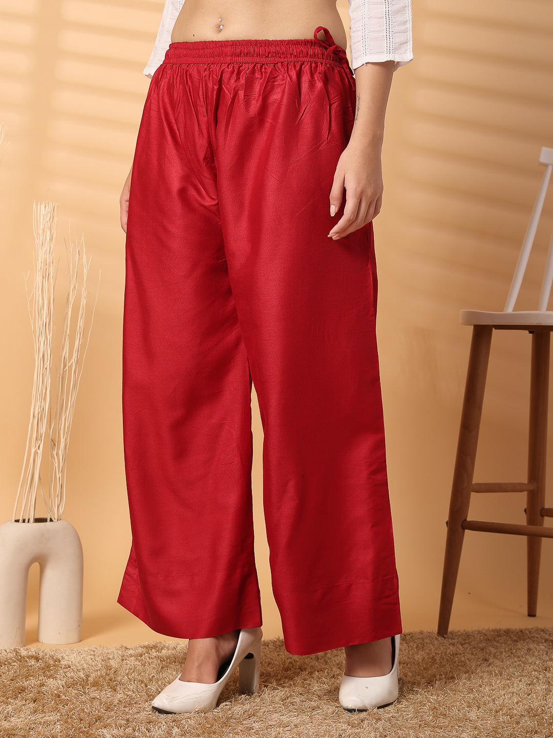 Red solid rayon straight palazzo with wide legs and elastic waistband.