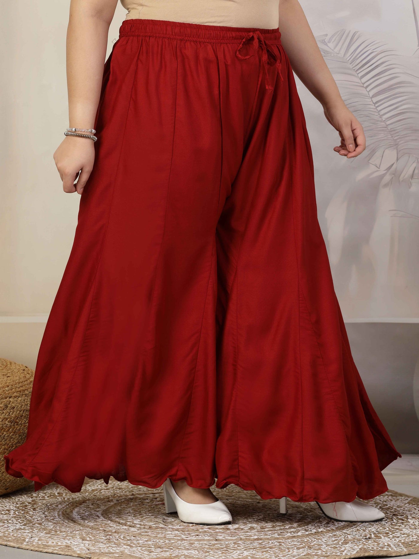 Women Solid Marron Flared Rayon Sharara with elasticated waistband and drawstring.